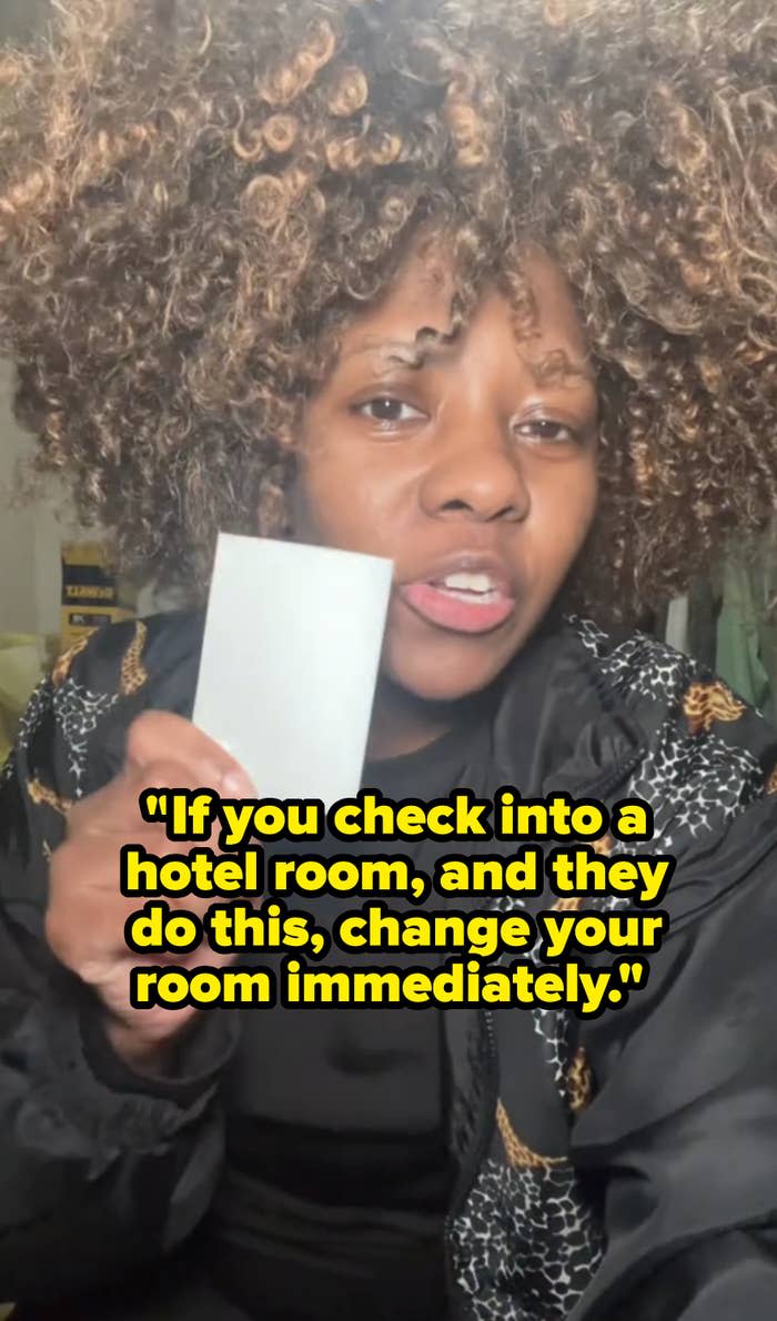 Patrice holds a hotel room card to the camera in her TikTok video with the text, "If you check into a hotel room, and they do this, change your room immediately"