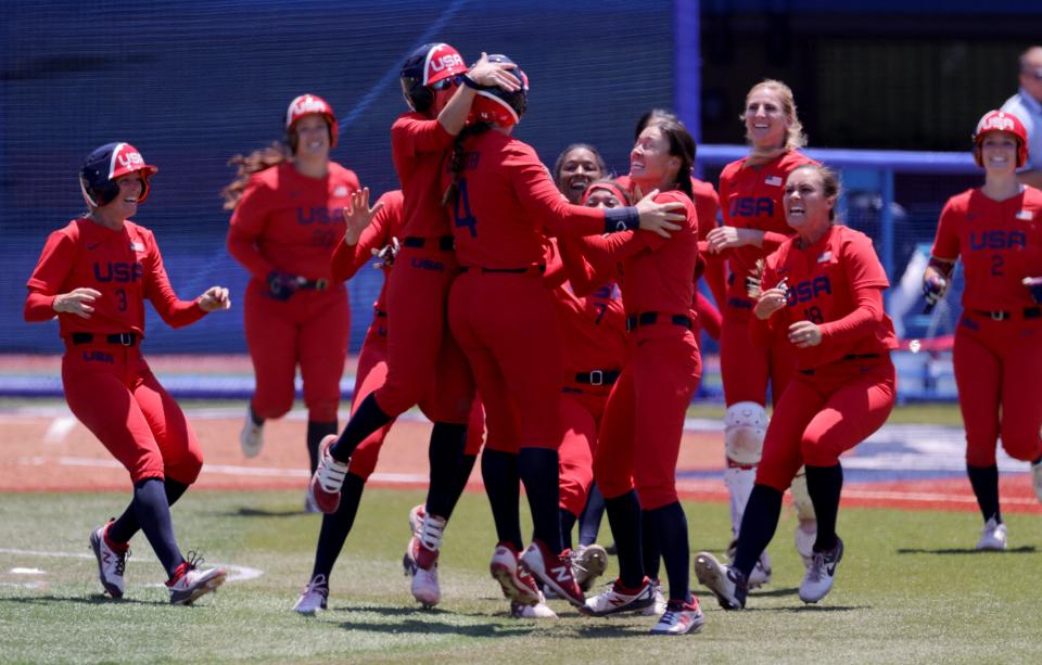 USA's softball players celebrate their walk-off victory during the extra eighth inning of the Tokyo 2020 Olympic Games softball opening round game between Australia and USA at Yokohama Baseball Stadium in Yokohama, Japan, on July 25, 2021. (Photo by KAZUHIRO FUJIHARA / AFP) (Photo by KAZUHIRO FUJIHARA/AFP via Getty Images)