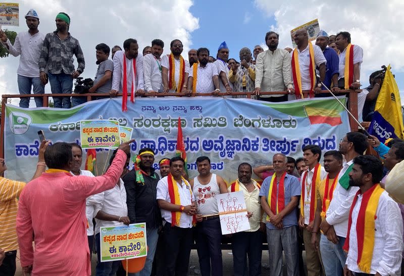 Demonstrators hold placards as they attend a protest, in Bengaluru