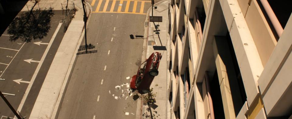 Car hanging from side of the road