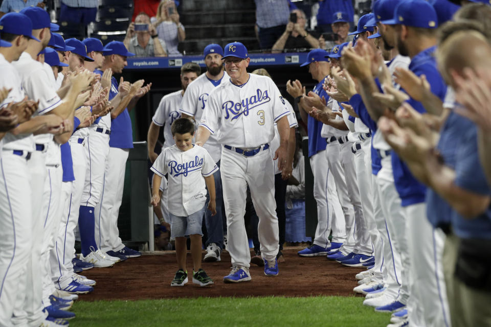 Kansas City Royals manager Ned Yost (3) walks his family between players during a ceremony before a baseball game against the Minnesota Twins at Kauffman Stadium in Kansas City, Mo., Friday, Sept. 27, 2019. Yost announced he will retire after Sunday's game. (AP Photo/Orlin Wagner)