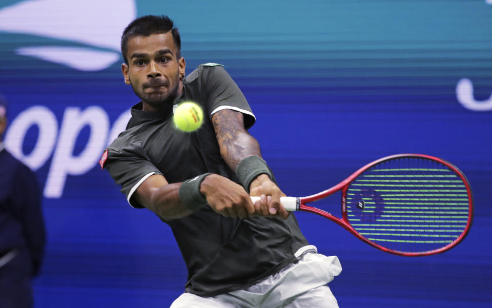 Sumit Nagal returns to Roger Federer during the first round of the U.S. Open tennis tournament in New York, Monday, Aug. 26, 2019. (AP Photo/Charles Krupa)