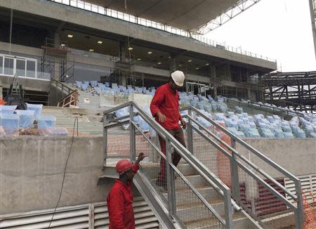 A worker walks down a stair in the construction of the Arena Pantanal soccer stadium, which will host several matches of the 2014 World Cup, in Cuiaba, February 13, 2014. REUTERS/Brian Winter