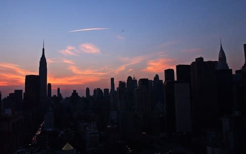The New York City skyline is shown Thursday, Aug. 14, 2003. A massive power outage struck the eastern United States and parts of Canada on Thursday afternoon, stranding people in sweltering subways and sending office workers streaming into the streets in 90-degree heat.  - Credit: FRANK FRANKLIN II/ AP