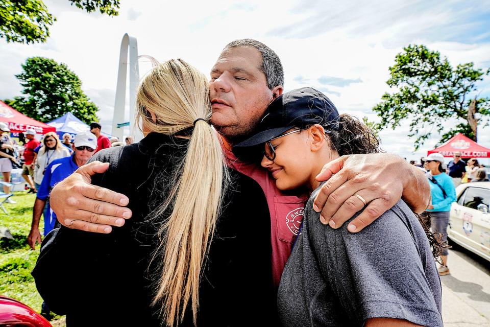 Last year's Great Race winners, sisters Jenna Gentry, left, the navigator, and Olivia Gentry, the driver, get a hug before the race from their father, Oliver Gentry. They all live in Newnan Georgia. The women were driving a 1932 Ford Coupe.