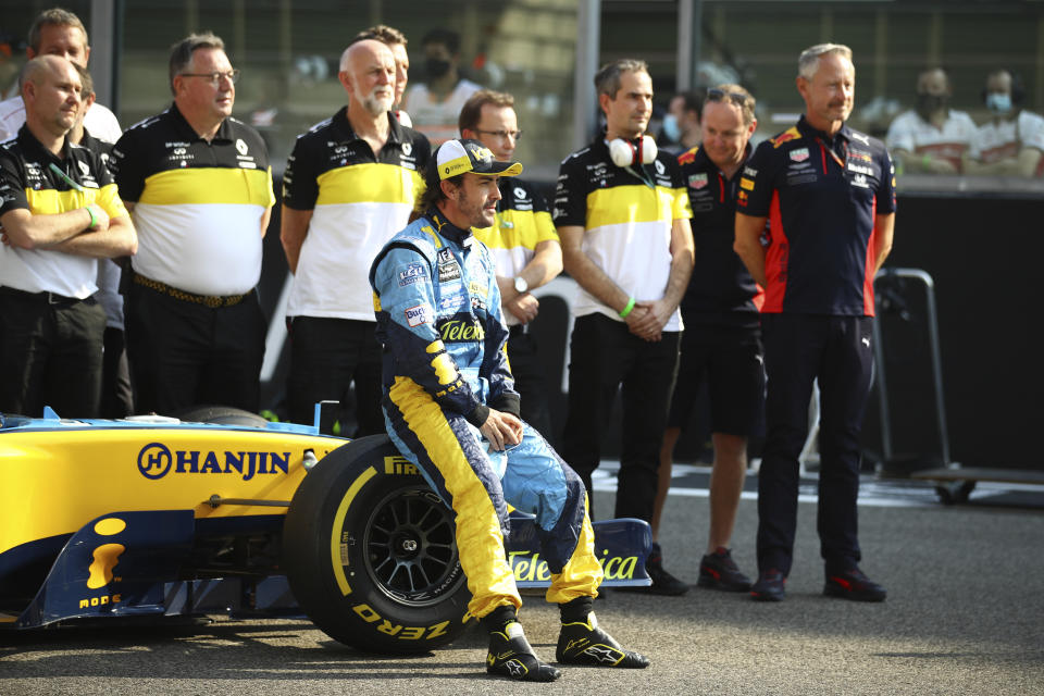 Renault's Spanish driver Fernando Alonso sits on the wheel of his Renault R25 car ahead of his demonstration laps prior to the Abu Dhabi Formula One Grand Prix in the Yas Marina racetrack in Abu Dhabi, United Arab Emirates, Sunday, Dec.13, 2020. (Brynn Lennon, Pool via AP)