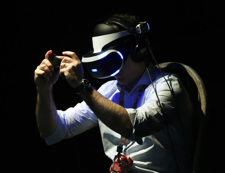 A gamer tests a new virtual reality game headset at the Electronic Entertainment Expo in Los Angeles, California