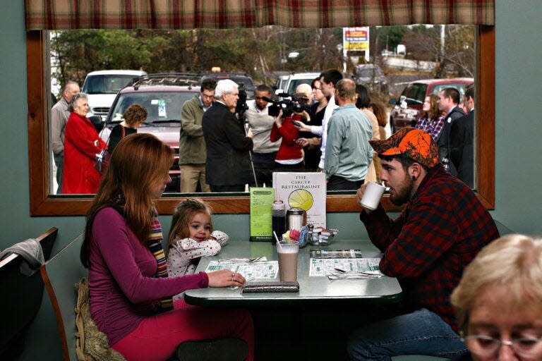 Republican candidate Newt Gingrich speaks to the press outside an Epsom restaurant in 2011.