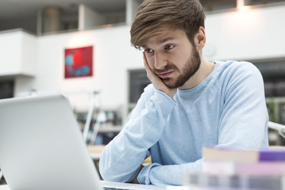 Student using laptop in a university library