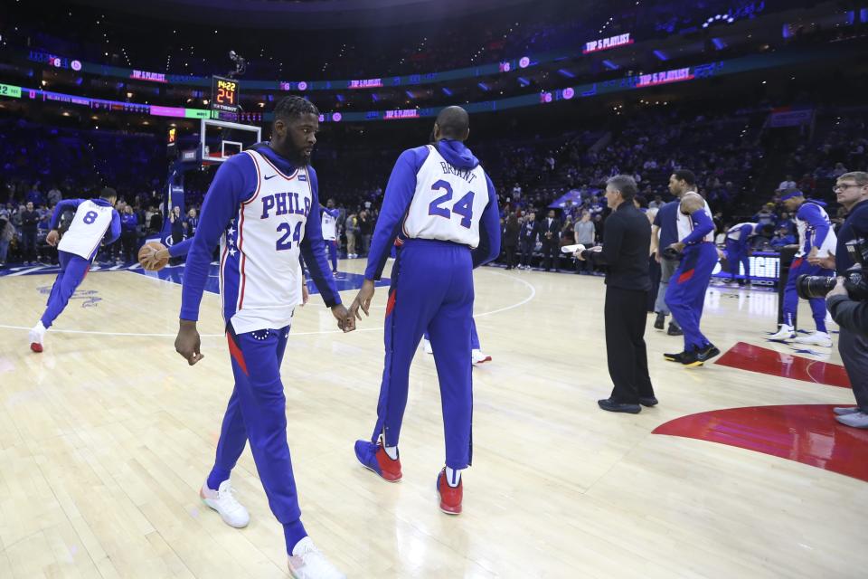 Philadelphia 76ers' James Ennis III and teammates wear jerseys with Kobe Bryant's No. 24 on them, before the team's NBA basketball game against the Golden State Warriors on Tuesday, Jan. 28, 2020, in Philadelphia. (Steven M. Falk/The Philadelphia Inquirer via AP)