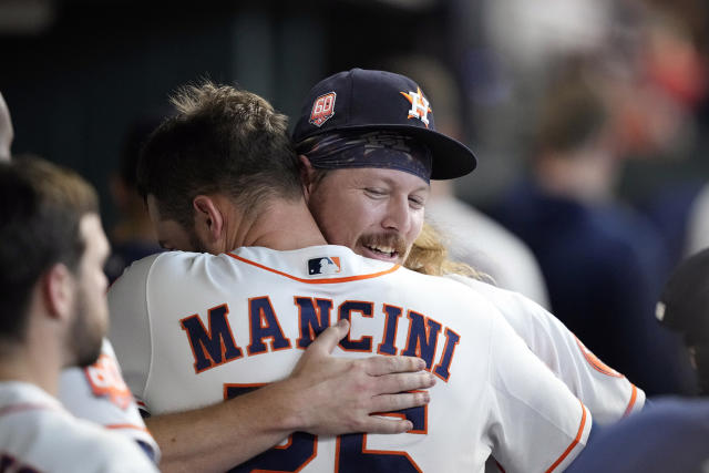 Houston Astros' Christian Vazquez (9) is hugged by former teammate