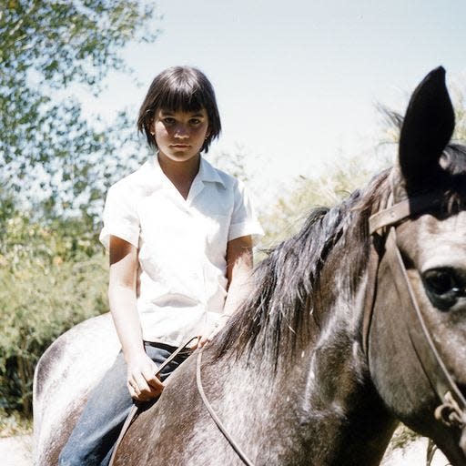 A young Linda Ronstadt on horseback.