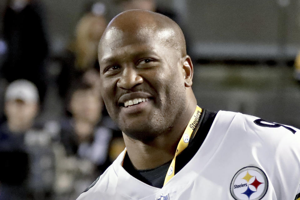 FILE - Former Pittsburgh Steelers linebacker James Harrison smiles during a halftime ceremony honoring former Steelers players at an NFL football game between the Pittsburgh Steelers and the Los Angeles Chargers, Sunday, Dec. 2, 2018, in Pittsburgh. Harrison is one of five first-year eligible players among 28 modern day semifinalists for the Pro Football Hall of Fame's class of 2023. (AP Photo/Gene J. Puskar, File)