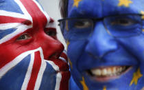 FILE - In this Thursday, March 21, 2019 file photo, activists pose with their faces painted in the EU and Union Flag colors during an anti-Brexit campaign stunt outside EU headquarters during an EU summit in Brussels. The country's struggle to leave the European Union is one of the great political crisis to afflict Britain in the postwar period. (AP Photo/Frank Augstein, File)