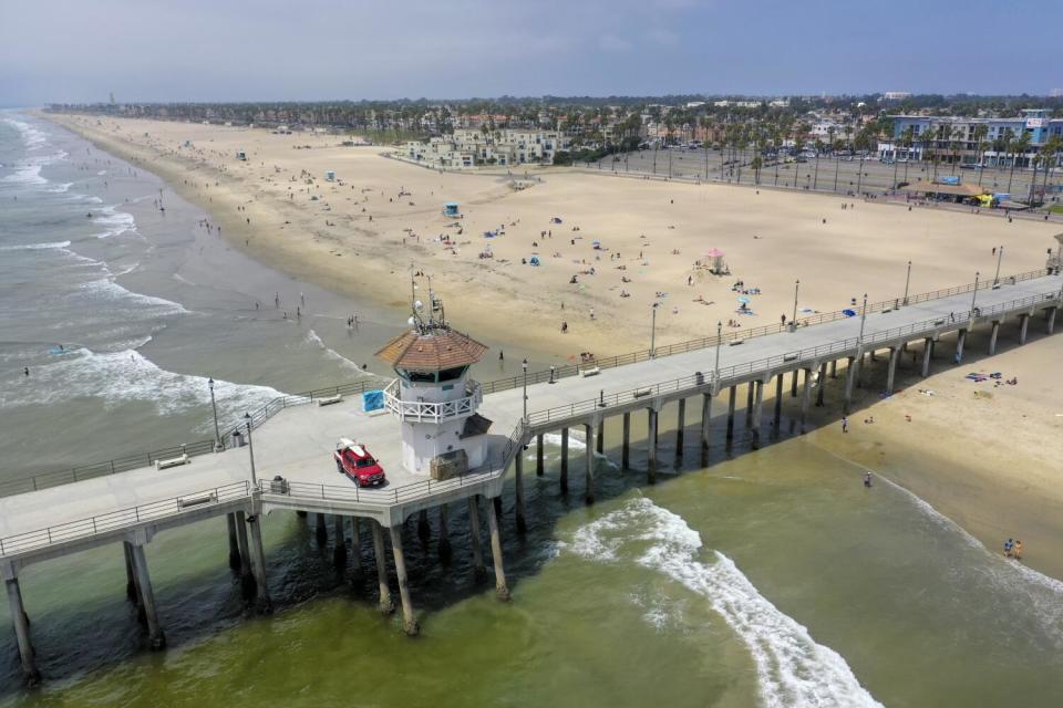 An aerial view of beach-goers enjoying the last day of open beaches in Huntington Beach