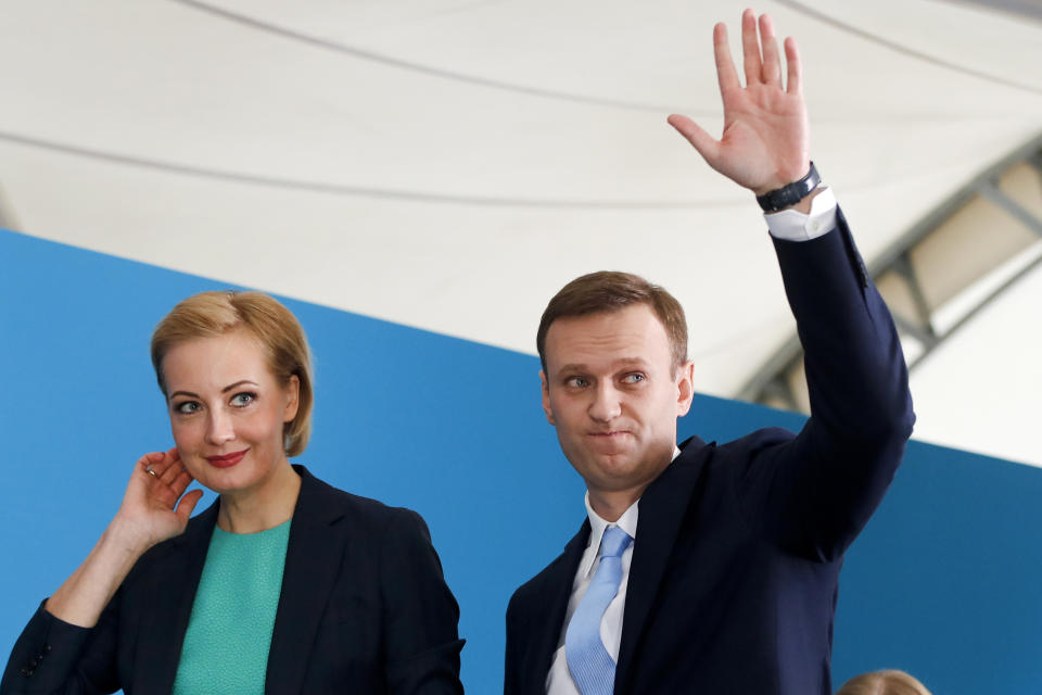 FILE - In this Dec. 24, 2017, file photo, Russian opposition leader Alexei Navalny and his wife Yulia attend his supporters' meeting that nominated him for the presidential election race in Moscow, Russia. Navalny remained hospitalized for a second day on Monday, July 29, 2019, after his physician said he may have been poisoned. Details about Navalny's condition were scarce after Navalny was rushed to a hospital Sunday from a detention facility where he was serving a 30-day sentence for calling an unsanctioned protest. (AP Photo/Pavel Golovkin, File)