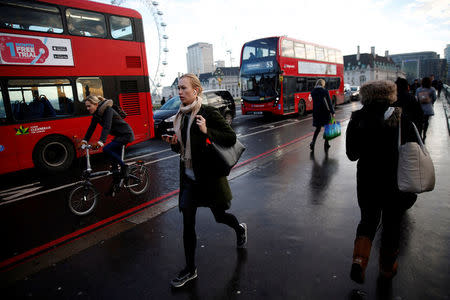 FILE PHOTO: People walk, cycle and ride buses accross Westminster Bridge on the second day of a train strike in London, Britain December 14, 2016. REUTERS/Neil Hall/File Photo