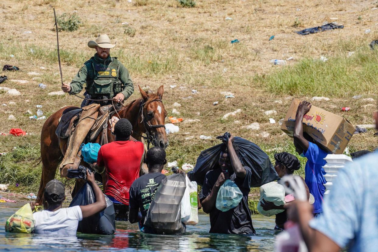 A U.S. Border Patrol agent on horseback uses the reins as he tries to stop Haitian migrants from entering an encampment on the banks of the Rio Grande near the Acuna Del Rio International Bridge in Del Rio, Texas on Sunday, September 19. 