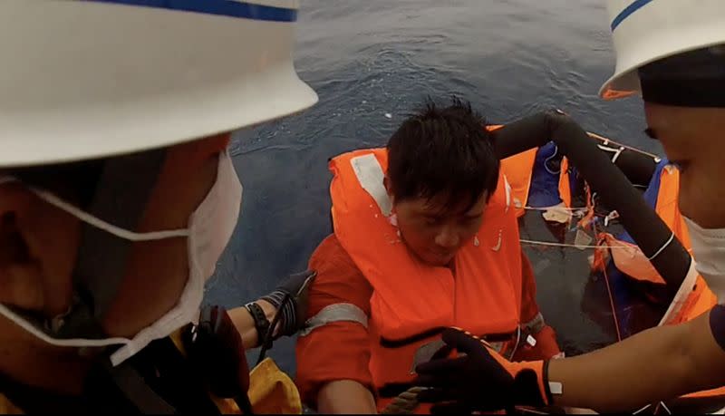 Filipino crew member of the Gulf Livestock 1 is rescued by Japan Coast Guard's crew members boarding the vessel Kaimon, at the East China Sea