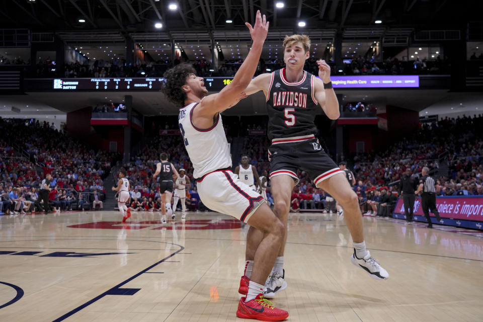 Davidson guard Grant Huffman, right, collides with Dayton forward Nate Santos, left, during the first half of an NCAA college basketball game, Tuesday, Feb. 27, 2024, in Dayton, Ohio. (AP Photo/Aaron Doster)