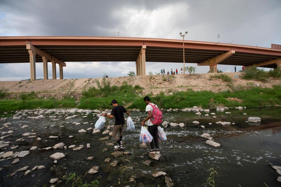 Venezuelan migrants make their way across the Rio Grande River in a return trip to El Paso after buying food in Juárez, Mexico. The migrants had waited hours to be processed by U.S. Customs and Border Protection.