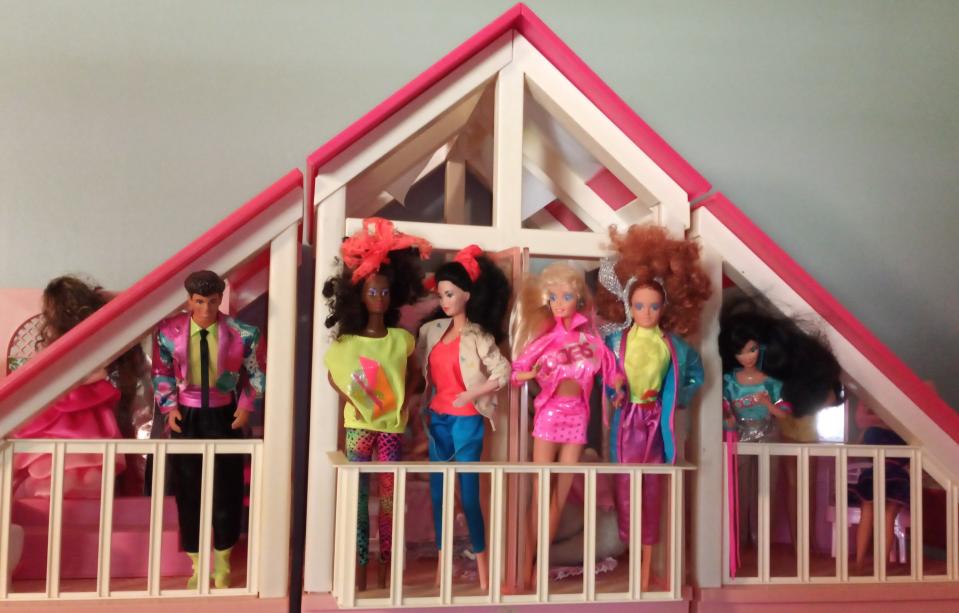 Barbie and the Rockers dolls lean out of a Barbie Dream House from the 1980s. The dolls, which were also released during the 1980s, were some of Melinda Umezaki's favorite and most memorable dolls from her childhood.