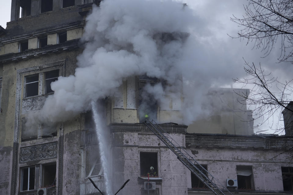 Firefighters work at the site after a Russian attack in Kyiv, Ukraine, Thursday, March 21, 2024. Around 30 cruise and ballistic missiles were shot down over Kyiv on Thursday morning, said Serhii Popko, the head of Kyiv City Administration. The missiles were entering Kyiv simultaneously from various directions in a first missile attack on the capital in 44 days. (AP Photo/Vadim Ghirda)