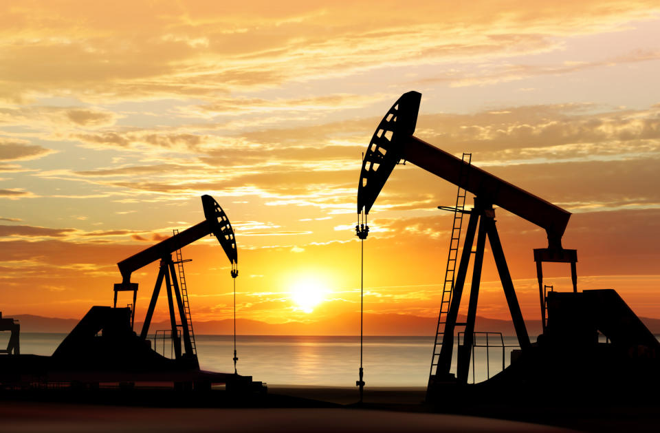 Oil pumps silhouetted against a sunset.