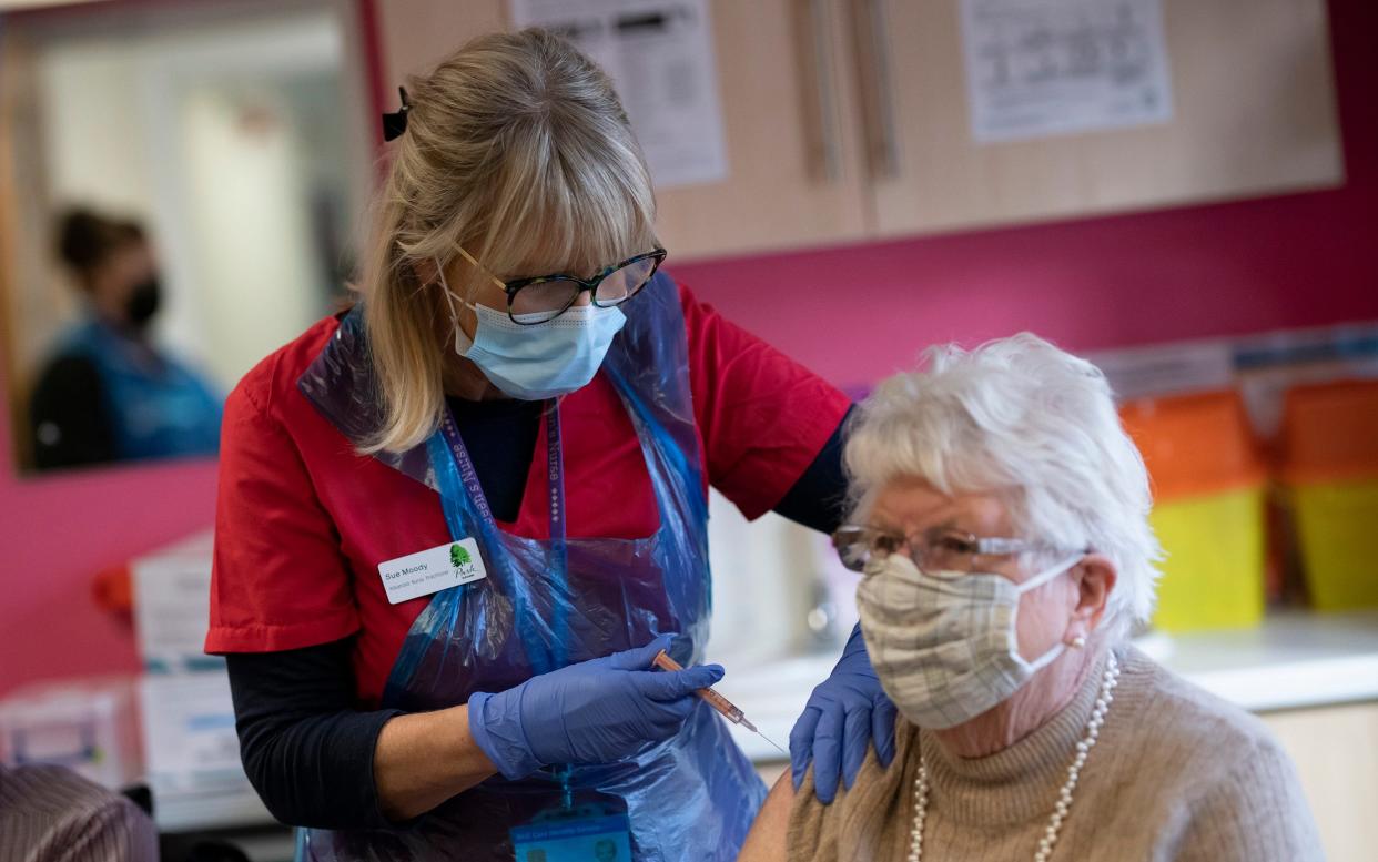 Advanced nurse practitioner Sue Moody administers the coronavirus vaccine as patients in their 80s are vaccinated at the Park Surgery GP practice in Horsham, West Sussex - Christopher Pledger