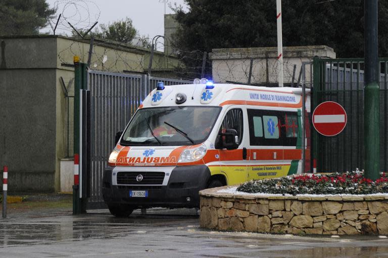 An ambulance carrying several injured passengers evacuated by helicopter from the burning ferry "Norman Atlantic" adrift off Albania, leaves the Fortunato Cesari military airport in Galatina, southern Italy, on December 28, 2014