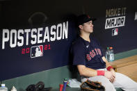 Boston Red Sox first baseman Bobby Dalbec sits in the dugout after their loss against the Houston Astros in Game 6 of baseball's American League Championship Series Friday, Oct. 22, 2021, in Houston. The Astros won 5-0, to win the ALCS series in game six. (AP Photo/Tony Gutierrez)