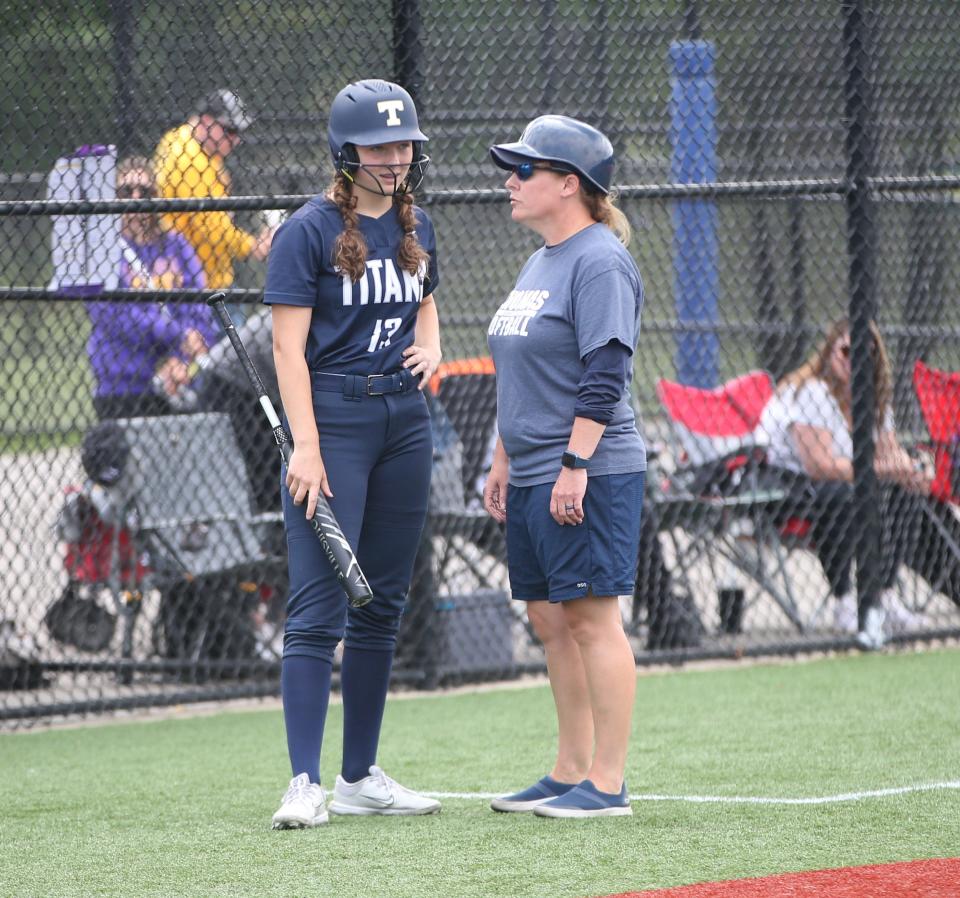 Webster Thomas' Maddie Throumoulos gets a word from head coach, Emily Castro, during the New York State Softball Championship semifinal versus Troy on June 9, 2023. 