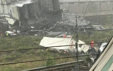 Emergency workers attend crushed trucks and cars - Credit:  REX/Shutterstock