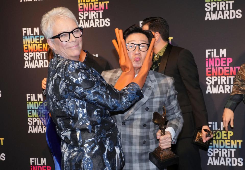 Jamie Lee Curtis, left, wearing hot dog fingers based on a prop from the film "Everything Everywhere All at Once," poses in the press room with Ke Huy Quan at the Film Independent Spirit Awards on Saturday, March 4, 2023, in Santa Monica, Calif. The cast and crew won the award for best feature for "Everything Everywhere All at Once." (Photo by Jordan Strauss/Invision/AP) ORG XMIT: CADA668