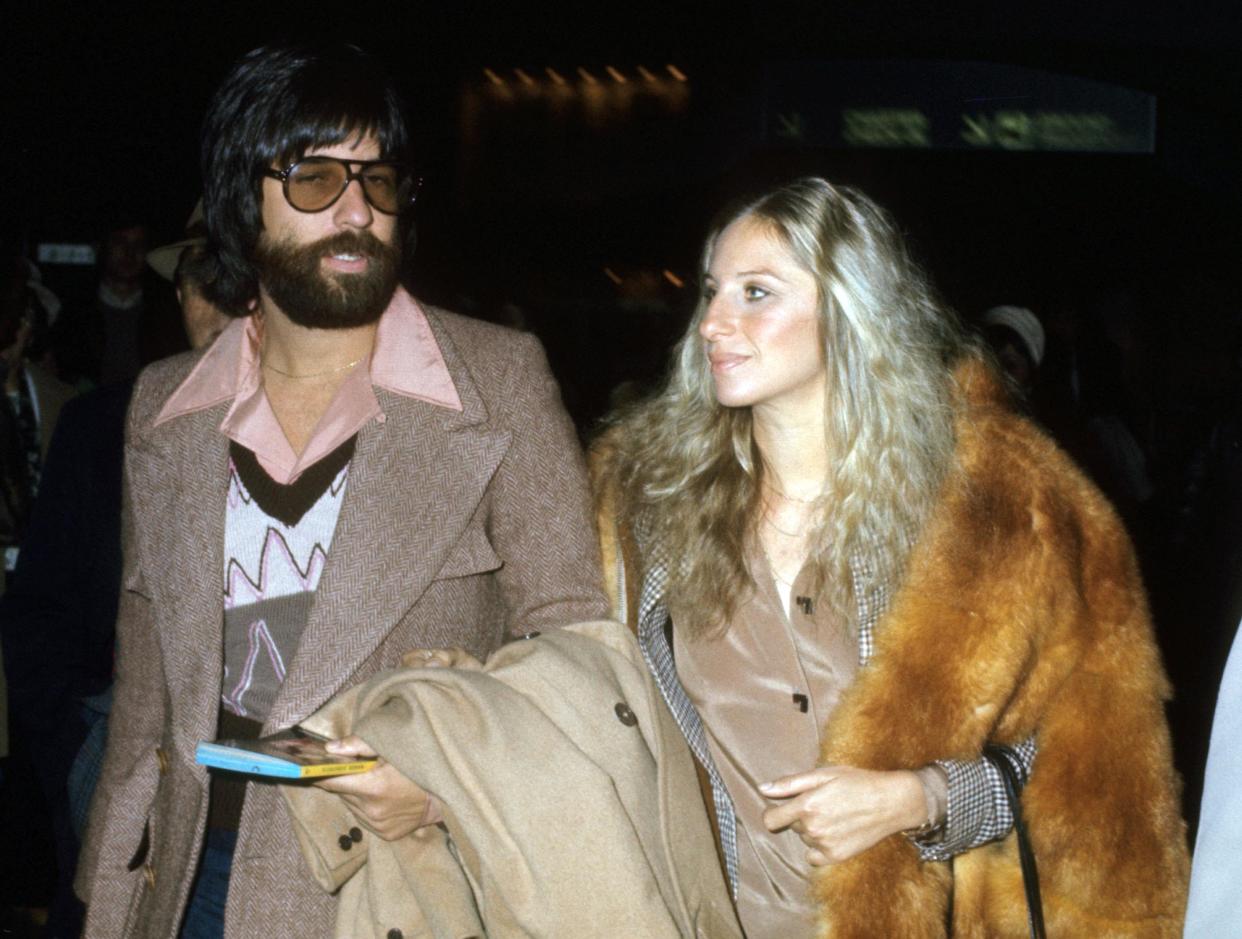 Jon Peters and Barbara Streisand holding arms