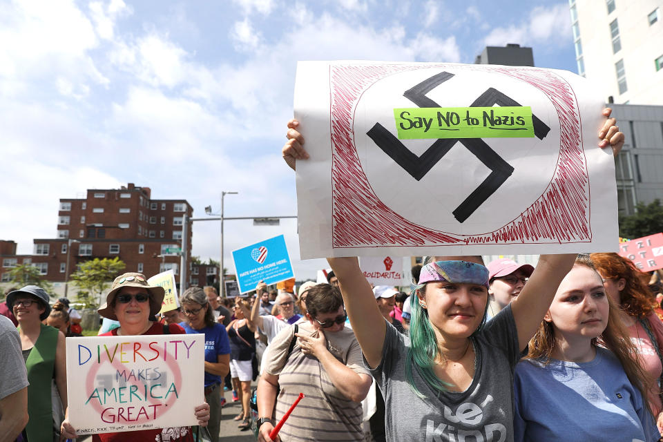 <p>Counter-protesters carried pro-diversity and anti-Nazi signs as they marched through the streets.</p>