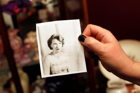 Lisa Stauffer holds a photo of her late mother-in-law Doris Stauffer, taken when she was 16 years old, in Surprise, Arizona, U.S. December 21, 2016. REUTERS/Ricardo Arduengo