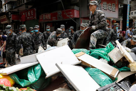 People’s Liberation Army (PLA) soldiers clean debris after Typhoon Hato hits in Macau, China August 25, 2017. REUTERS/Tyrone Siu