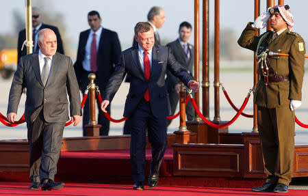 Jordan's King Abdullah II welcomes Iraqi Prime Minister Haider al-Abadi during a reception ceremony at the Queen Alia International Airport in Amman, Jordan March 28, 2017. REUTERS/Muhammad Hamed