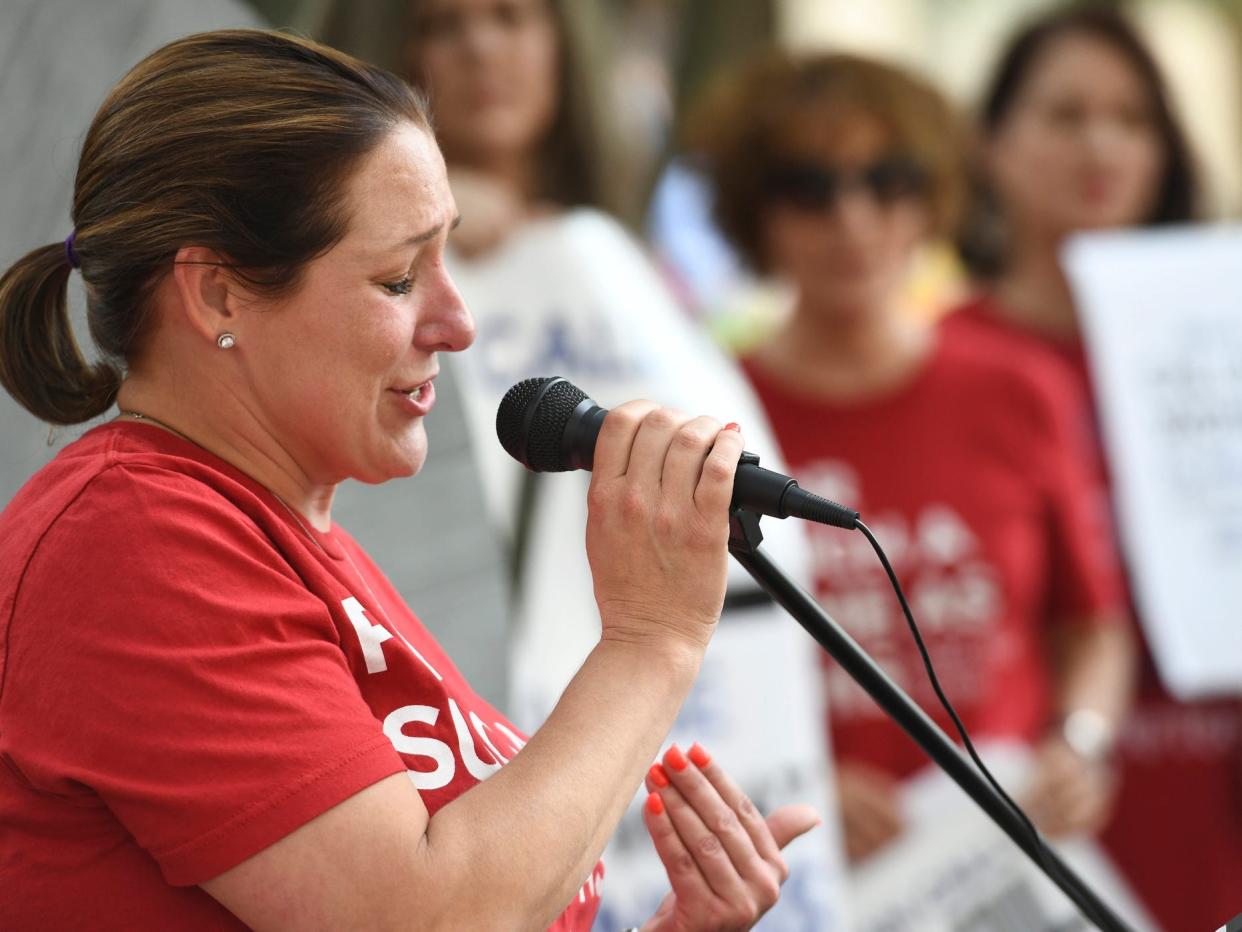 Jules Woodson, of Colorado Springs, Colo., speaks during a rally outside the Southern Baptist Convention's annual meeting Tuesday, June 11, 2019, in Birmingham, Ala. First-time attendee Woodson spoke through tears as she described being abused sexually by a Southern Baptist minister.