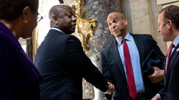 PHOTO: Sen. Tim Scott shakes hands with Sen. Cory Booker following a meeting about police reform legislation on Capitol Hill, May 18, 2021, in Washington. (Drew Angerer/Getty Images)