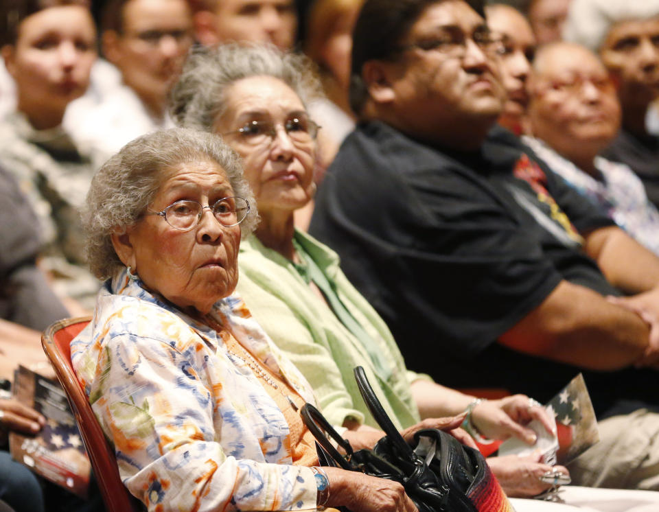 Irene Permansu Lane, left, the widow Comanche Code Talker Melvin Permansu, watches a video presentation during a ceremony honoring the code talkers presented by the Comanche National Museum and Cultural Center, in Lawton, Okla, Thursday, Sept. 26, 2013. (AP Photo/Sue Ogrocki)