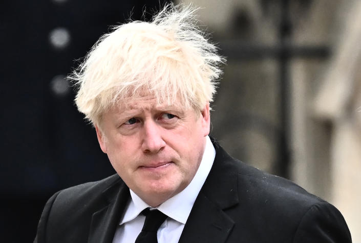 Image shows former British Prime Minister Boris Johnson in a white shirt, black suit and tie.