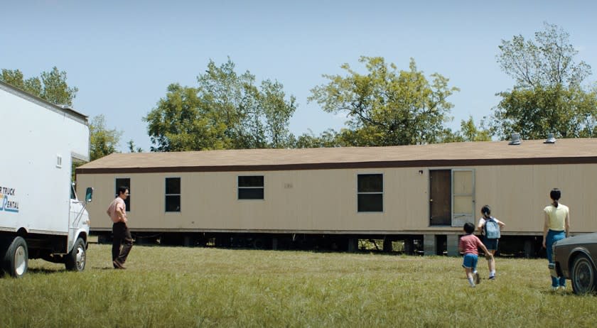 A still from "Minari" shows the family driving up to their future mobile home