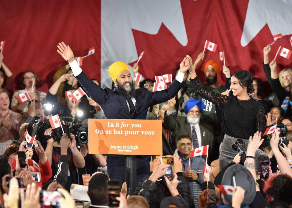 TOPSHOT - NDP leader Jagmeet Singh and his wife Gurkiran Kaur step on stage under the cheers of his supporters at the NDP Election Night Party in Burnaby BC, Canada, on October 21, 2019. - Prime Minister Justin Trudeau's Liberal Party held onto power in a nail-biter of a Canadian general election on Monday, but as a weakened minority government. Television projections declared the Liberals winners or leading in 157 of the nation's 338 electoral districts, versus 121 for his main rival Andrew Scheer and the Conservatives, after polling stations across six time zones closed. NDP Leader Jagmeet Singh failed to gain seats for the party. (Photo by Don MacKinnon / AFP) (Photo by DON MACKINNON/AFP via Getty Images)