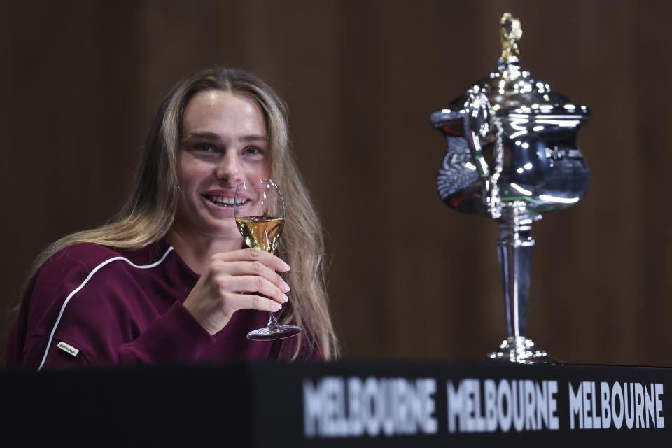 Aryna Sabalenka of Belarus takes a drink during a press conference following her win over Zheng Qinwen of China in the women's singles final at the Australian Open tennis championships at Melbourne Park, Melbourne, Australia, Saturday, Jan. 27, 2024. (AP Photo/Asanka Brendon Ratnayake)