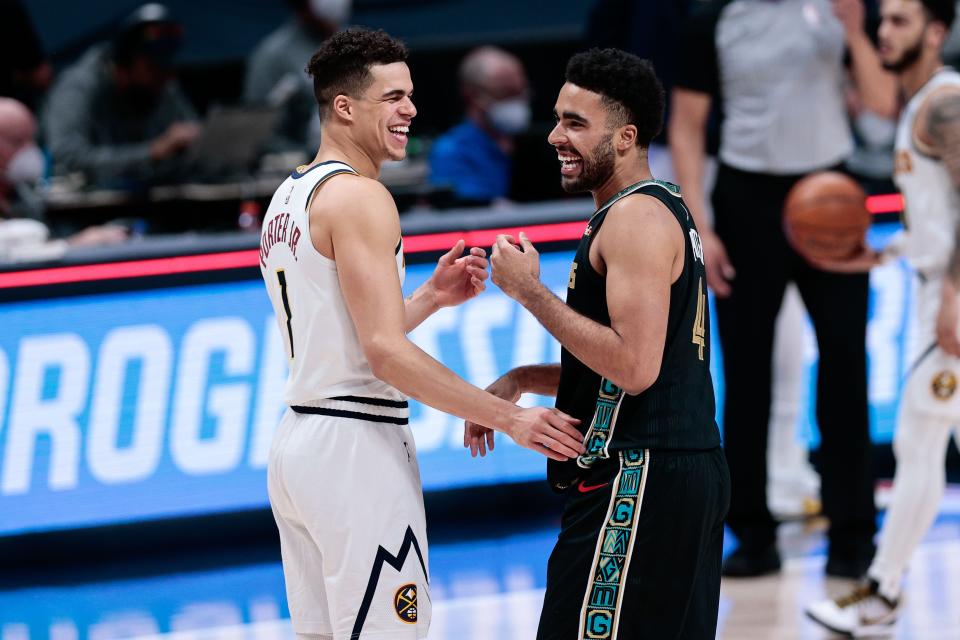 Denver Nuggets forward Michael Porter Jr. (1) greets his brother, Jontay Porter, after a 2021 game.