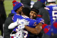 Buffalo Bills cornerback Josh Norman, right, hugs Levi Wallace (39) after an NFL divisional round football game against the Baltimore Ravens Saturday, Jan. 16, 2021, in Orchard Park, N.Y. The Bills won 17-3. (AP Photo/John Munson)