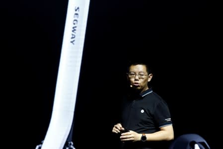 Ninebot President Wang Ye unveils semi-autonomous scooter KickScooter T60 that can return itself to charging stations without a driver, at a Segway-Ninebot product launch event in Beijing