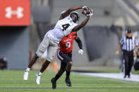 UCF wide receiver Ryan O'Keefe (4) makes a catch against Cincinnati cornerback Arquon Bush (9) during the first half of an NCAA college football game, Saturday, Oct. 16, 2021, in Cincinnati. (AP Photo/Aaron Doster)